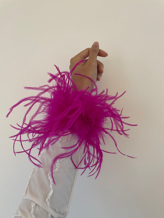 Pink color feather cuffs that are made on slap bracelets